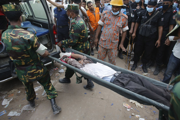 Rescue workers carry a garment worker alive from the rubble of the collapsed Rana Plaza building, in Savar, 30 km (19 miles) outside Dhaka April 26, 2013. (Reuters/Andrew Biraj)