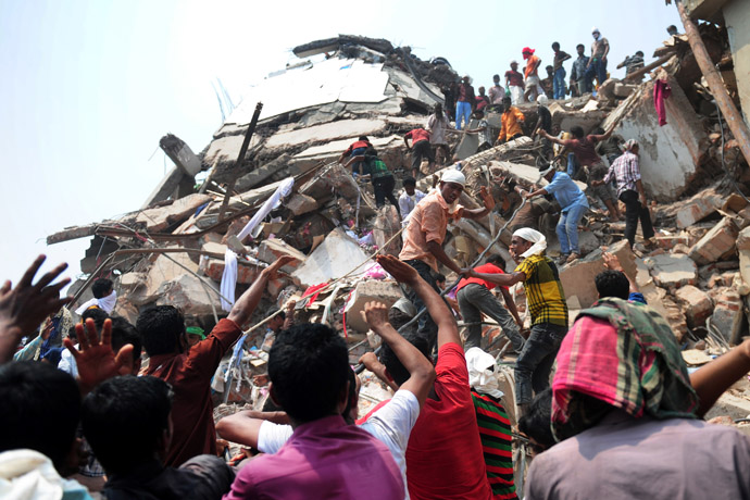 Bangladeshi volunteers and rescue workers assist in rescue operations 48 hours after an eight-storey building collapsed in Savar, on the outskirts of Dhaka, on April 26, 2013. (AFP Photo/Munir Uz Zaman)