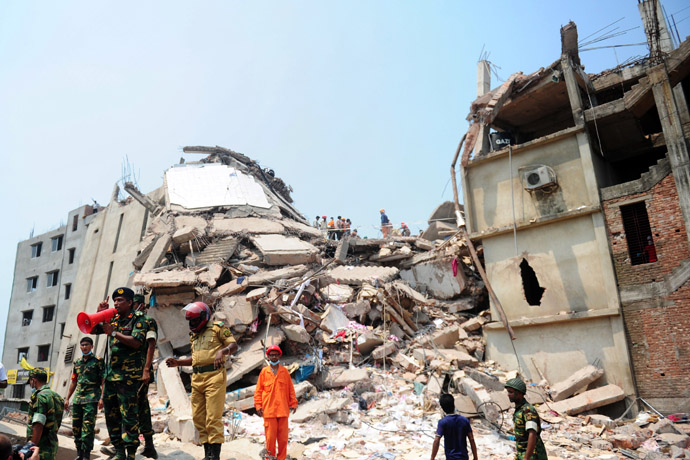 Bangladeshi army personal speak on a megaphone after relatives of the missing and dead burst into angry protests at the disaster site of an eight-storey building that collapsed 48 hours earlier in Savar, on the outskirts of Dhaka, on April 26, 2013. (AFP Photo/Munir Uz Zaman)