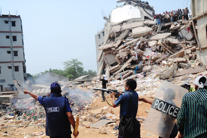 Bangladeshi police fire tear gas after relatives of the missing and dead burst into angry protests at the disaster site of an eight-storey building that collapsed 48 hours earlier in Savar, on the outskirts of Dhaka, on April 26, 2013. (AFP Photo/Munir Uz Zaman)