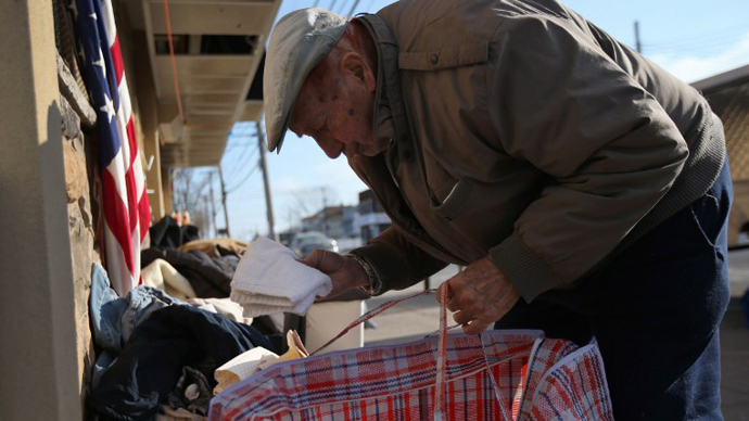 Michael Garo takes a set of towels from a Superstorm Sandy aid distribution center on January 4, 2013. (AFP Photo / John Moore)