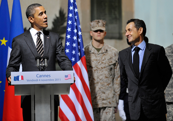  France's President Nicolas Sarkozy (R) listens to a speech by US President Barack Obama as they attend a Franco-American ceremony at the City Hall in Cannes, southern France, on November 4, 2011, at the end of the second day of G20 Summit (AFP Photo / Philippe Wajazer)