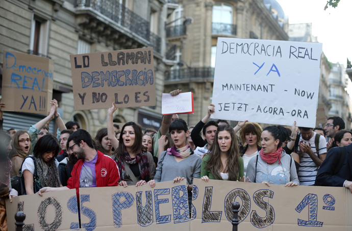 Demonstrators shout slogans and hold placards to protest against austerity cuts in Spain next to the Spanish Embassy in Paris, on May 19, 2011 (AFP Photo / Alexander Klein)