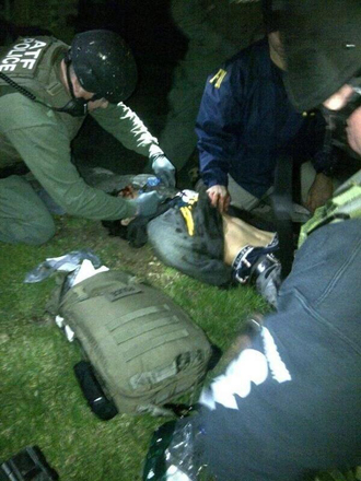 Dzhokhar Tsarnaev, 19, is searched by law enforcement officers in this handout photo provided by the Massachusetts State Police in Watertown, Massachusetts, April 19, 2013. (Reuters)