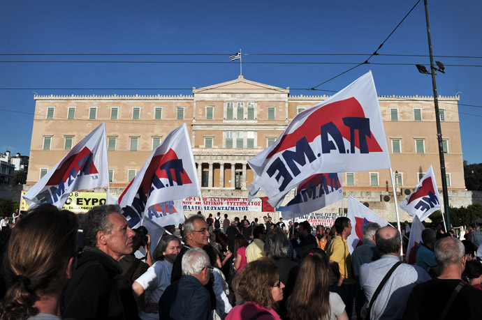 Protesters hold flags as they gather in front of the parliament in Athens on April 28, 2013. (AFP Photo/Louisa Gouliamaki)