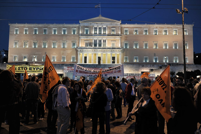 Demonstrators holding flags gather in front of the parliament in Athens on April 28, 2013. (AFP Photo/Louisa Gouliamaki)