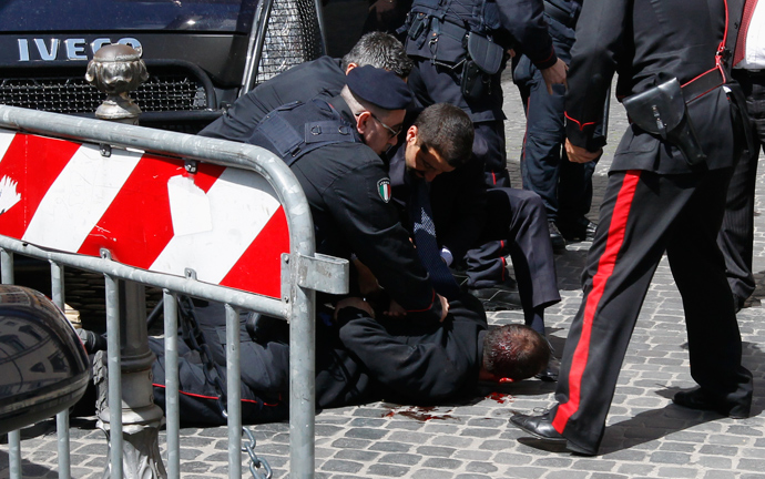 A man believed to be the shooter lies on the ground detained by Carabinieri after gunshots were fired in front of Chigi Palace in Rome April 28, 2013 (Reuters / Giampiero Sposito)