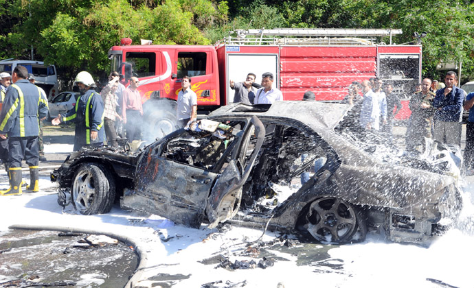 A handout picture released by the Syrian Arab News Agency (SANA) on April 29, 2013, shows fire fighters dousing the scene following a blast in the Mazzeh district of Damascus (AFP Photo/SANA)