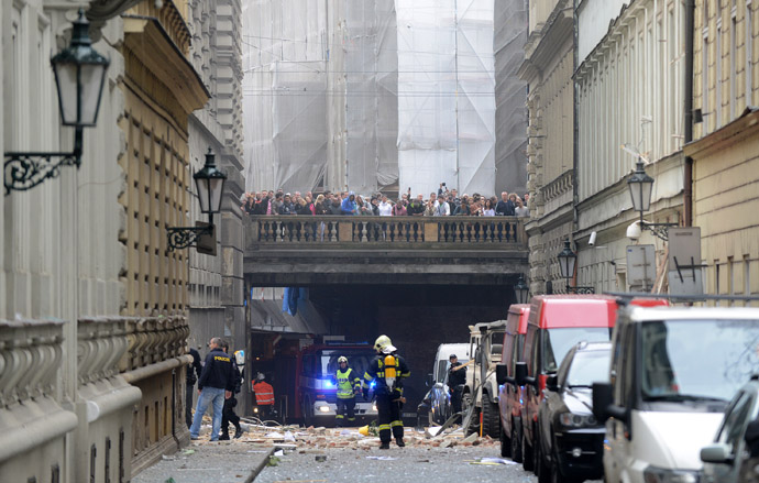  Firemen stand in front of a building damaged in a blast by on April 29, 2013 in Prague, Czech Republic. (AFP Photo/Michal Cizek)