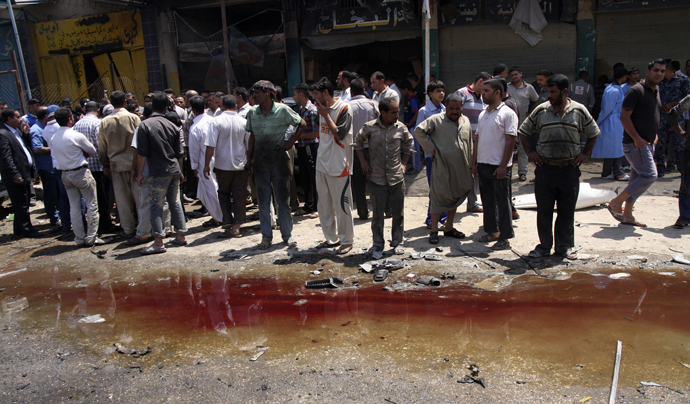 Residents look at a pool of blood after a car bomb attack in Kerbala, 110 km (70 miles) south of Baghdad, April 29, 2013. (Reuters)