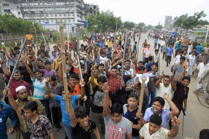 Garment workers shout slogans as they block a street during a protest to demand capital punishment for those responsible for the collapse of the Rana Plaza building in Savar, outside Dhaka April 30, 2013. (Reuters/Sajid Hossain)