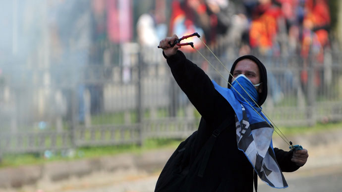 A protestor uses a slingshot during clashes with police at a May Day demonstration on May 1, 2013.(AFP Photo / Ozan Kose) 