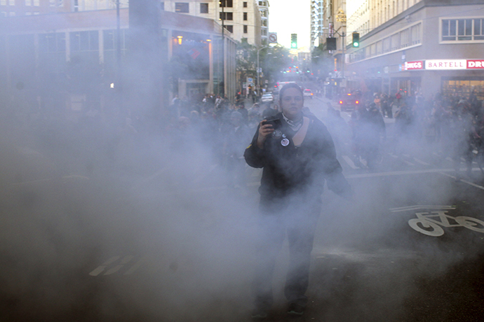 A demonstrator walks through flash bang smoke during May Day demonstrations in Seattle, Washington May 1, 2013. (Reuters / Matt Mills McKnight)