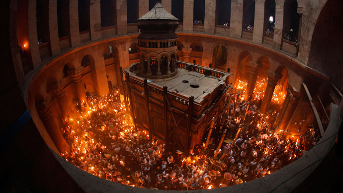 orshippers hold candles as they take part in the Christian Orthodox Holy Fire ceremony at the Church of the Holy Sepulchre in Jerusalem's Old city May 4, 2013.(Reuters / Ammar Awad)