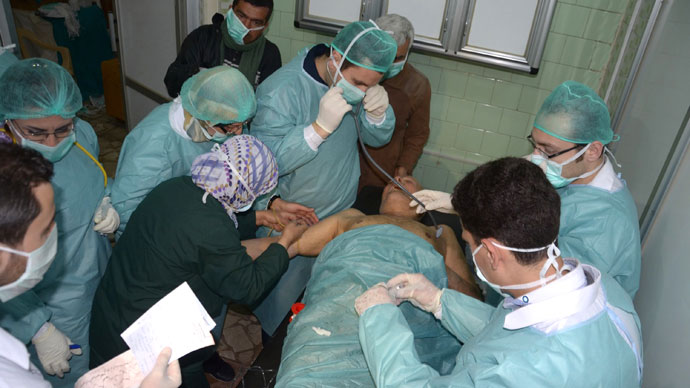 Medics and other masked people attend to a man at a hospital in Khan al-Assal in the northern Aleppo province, as Syria's government accused rebel forces of using chemical weapons for the first time. The opposition denied the claim, saying instead that government forces might have used banned weapons.(AFP Photo / HO-SANA)