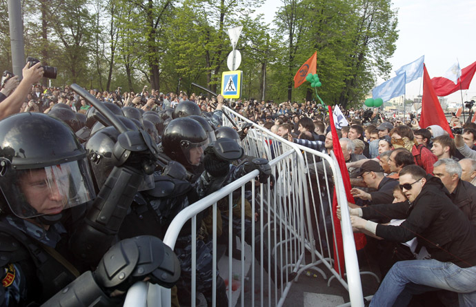 Riot police try to remove fences from participants of an opposition protest in central Moscow May 6, 2012. (Reuters/Denis Sinyakov)