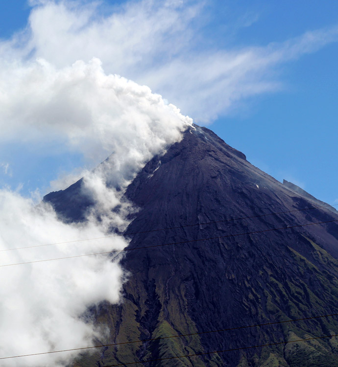 Volcano Mount Mayon spews a thick column of ash 500 metres (1,600 feet) into the air, as seen from the city of Legazpi, albay province, southeast of Manila on May 7, 2013. (AFP Photo/Charism Sayat)