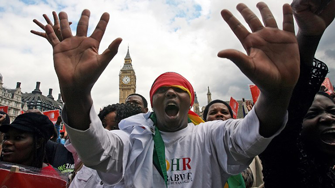 The "Strangers into Citizens" group organised a rally in front of the Houses of Parliament, asking the government to allow Zimbabwean immigrants the right to work and pay taxes in the United Kingdom. (AFP Photo / Leon Neal)