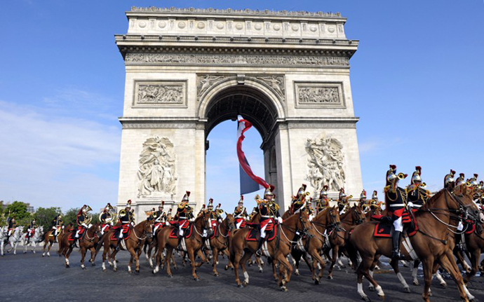 France's Republican Guards ride down the Champs Elysees in front of the Arc de Triomphe. (AFP Photo / Philippe Wojazer)
