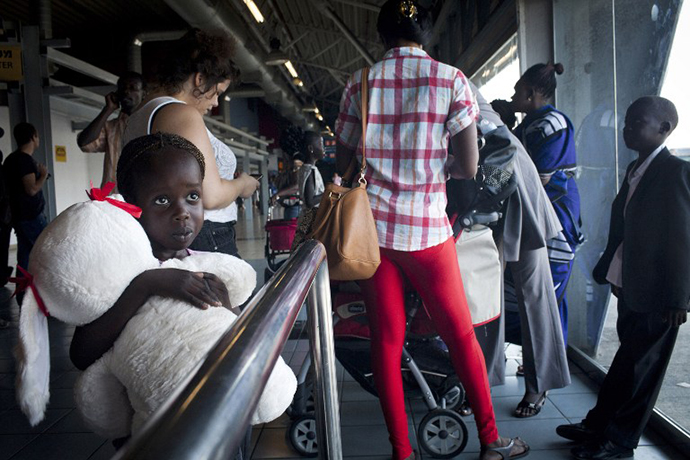 South Sudanese refugees board a bus taking them to Ben Gurion International airport, near Tel Aviv. (AFP Photo / Oren Ziv)