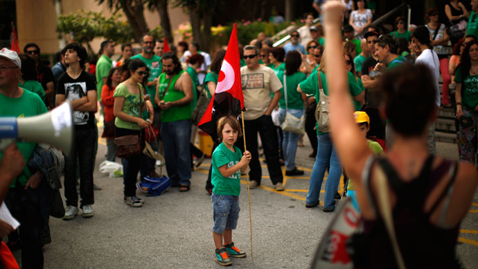 Students, teachers and parents protest against the government's cost-cutting reform plans in education as part of austerity measures, in front of the Education Delegation building in Malaga, southern Spain May 9, 2013.(Reuters / Jon Nazca)