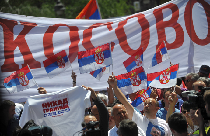 Demonstrators hold a banner reading "Kosovo" and wave flags during a protest against the accord on the normalisation of relations between Serbia and Kosovo in the Serbian capital Belgrade on May 10, 2013 (AFP Photo / Andrey Isakovic)