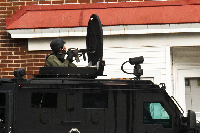 A SWAT police officer stands guard near the suspect's house (not pictured) in Trenton, New Jersey, May 11, 2013. (Reuters)