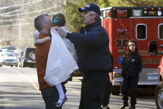A young girl is given a blanket after being evacuated from Sandy Hook Elementary School following a shooting in Newtown, Connecticut, December 14, 2012. (Reuters)