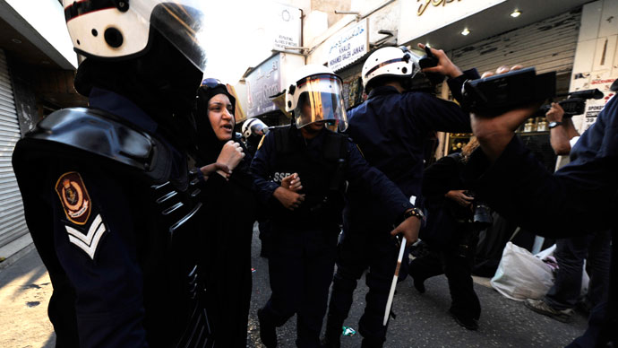 Women riot police detain an anti-government protester in Manama.(Reuters / Stringer)