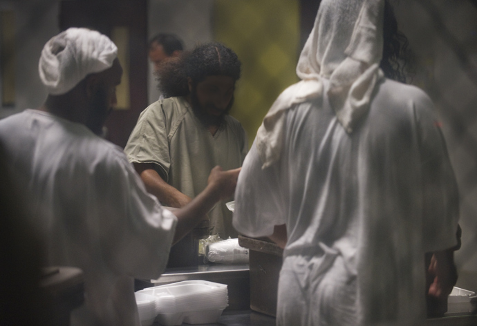 In this photo reviewed by US military officials, detainees using towels as head dress are seen inside Camp VI as they gather at a cart rolled into the communial area with thier noon meal inside the US Detention Center in Guantanamo Bay, Cuba (AFP Photo / Paul J. Richards)