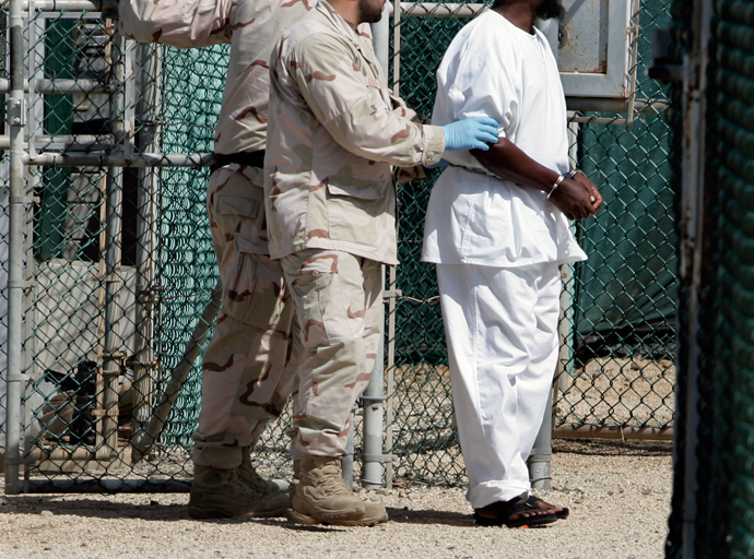 A detainee is escorted by U.S. Navy guards in Camp Four, the facility containing the "most compliant" detainees, at the Guantanamo Bay Naval Station in Guantanamo Bay, Cuba (Reuters / Joe Skipper)
