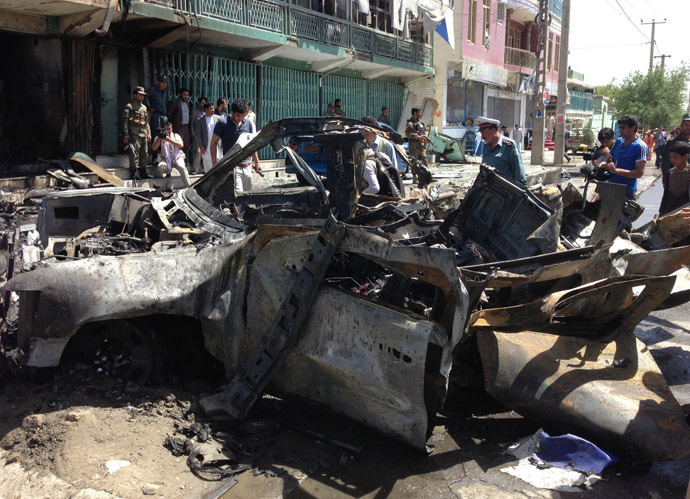 Afghan security and media representatives gather at the scene of an explosion in Kabul on May 16, 2013. (AFP Photo)