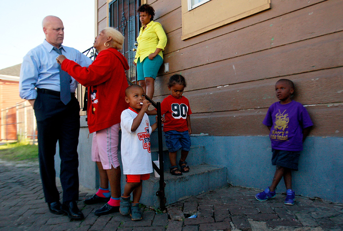 New Orleans Mayor Mitch Landrieu speaks with Jane Lewis out side her home where a shooting during a Mother's Day parade took place, on May 13, 2013 in New Orleans, Louisiana (AFP Photo / Sean Gardner)