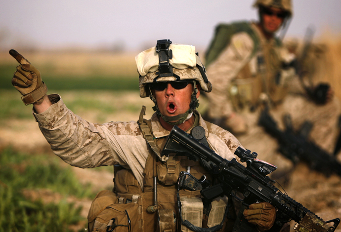 A US 1/3 Marine Weapons Company officer issues orders as marines advance against Taliban on the northeast of Marjah on February 14, 2010. (AFP Photo / Patrick Baz)