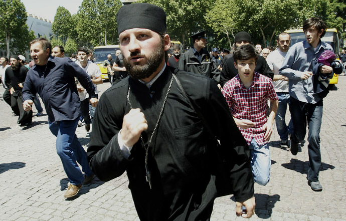 Orthodox Christian activists run during clashes with gay rights activists at an International Day Against Homophobia and Transphobia (IDAHO) rally in Tbilisi, May 17, 2013. (Reuters)