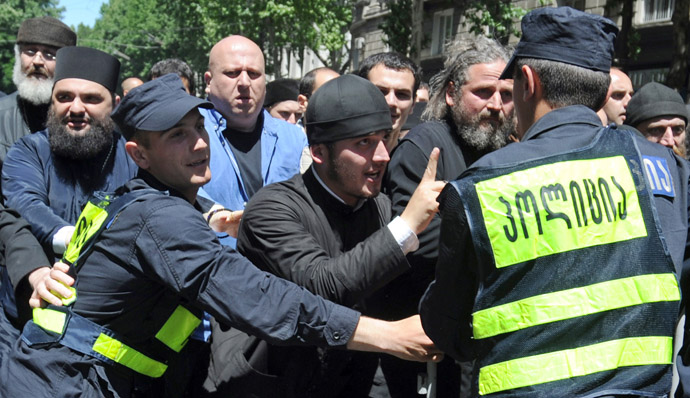 Georgian Orthodox believers and anti-gay activists clash with police officers as they demonstrate in the capital Tbilisi, on May 17, 2013, to protest against gay rights activists' plans to stage a rally marking the International Day against Homophobia. (AFP Photo)