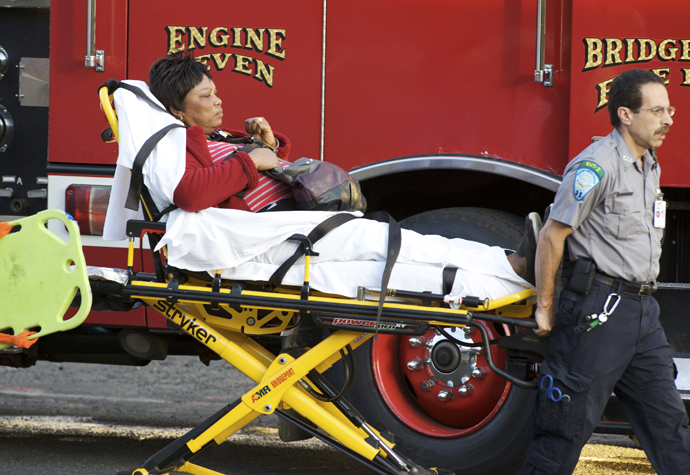 A woman is transported to the hospital after two commuter trains collided in Bridgeport, Connecticut May 17, 2013. (Reuters / Michelle McLoughlin)