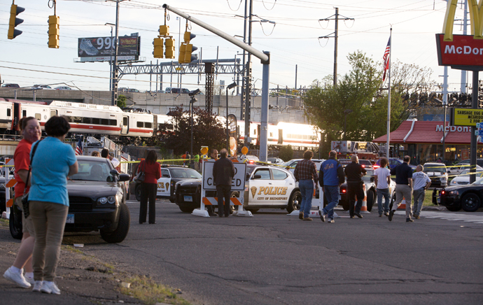 Onlookers gather at the scene of a collision of two commuter trains in Bridgeport, Connecticut May 17, 2013. (Reuters / Michelle McLoughlin)