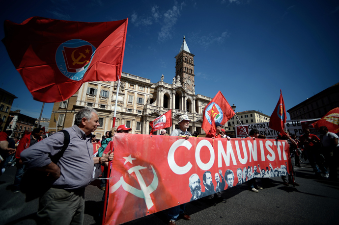 Demonstrators carry a banner reading "Communists" during the left-wing Italian metalworkers' union FIOM rally in downtown Rome on May 18, 2013 (AFP Photo / Filippo Monteforte)