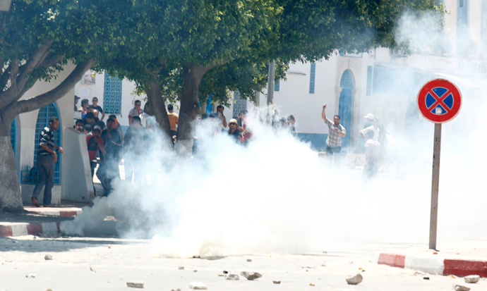 Tear gas is seen as protesters clash with riot police attempting to disperse the crowd in the city of Kairouan May 19, 2013 (Reuters / Zoubeir Souissi)