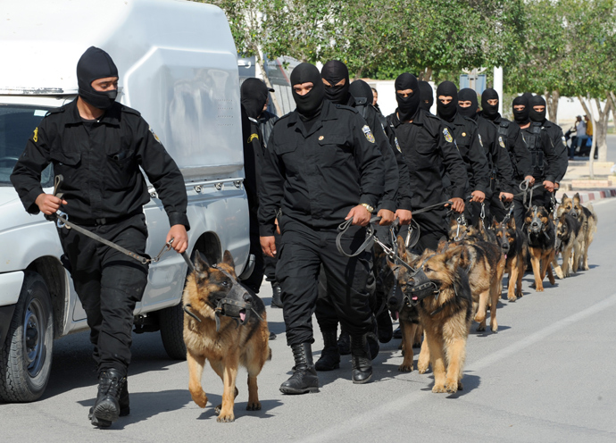 Tunisian Police Special Unit agents with dogs patrol in a street that leads to Okba Ibn Nafaa mosque in the central Tunisian city of Kairouan on May 19, 2013 (AFP Photo / Fethi Belaid)