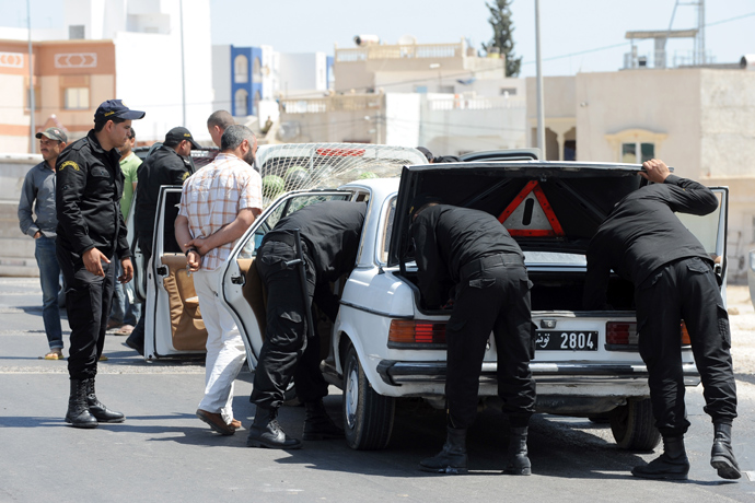 Tunisian Police Special Unit agents check vehicles driving on a road leading the central Tunisian city of Kairouan on May 19, 2013 (AFP Photo / Fethi Belaid)