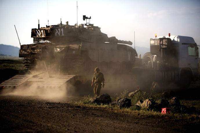 An Israeli Merkava tank is positioned for deployment during a drill in the Israeli annexed Golan Heights near the border with Syria on May 5, 2013. (AFP Photo / Menahem Kahana)