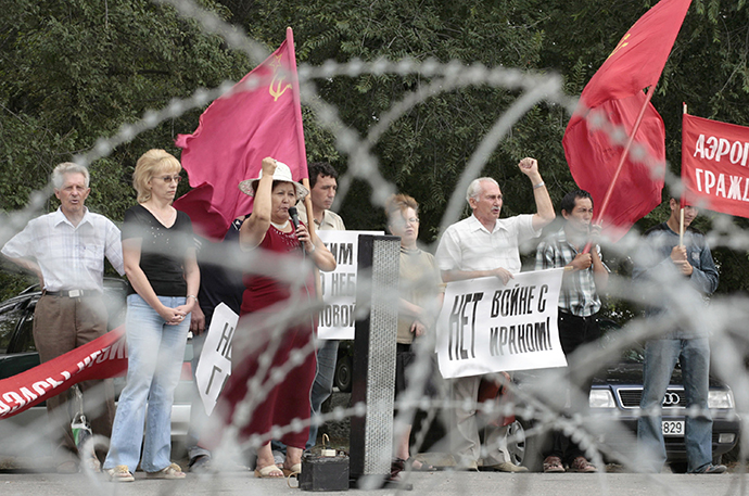 Protesters shout slogans calling for the withdrawl of U.S. military from Manas airport during a demonstration in front of the airbase near Bishkek July 7, 2007. The banner reads "No war with Iran!" (Reuters / Vladimir Pirogov)