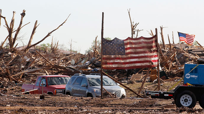 A U.S. flag from the Plaza Towers elementary school is erected on poles in front of the school in Moore, Oklahoma May 22, 2013.(Reuters / Rick Wilking)