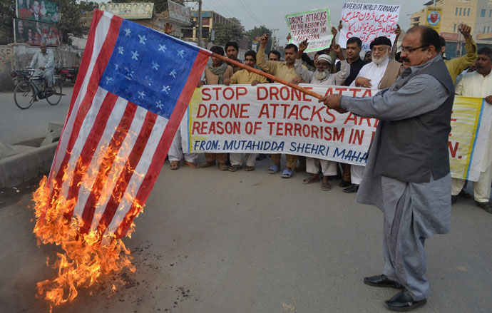 A demonstrator holds up a burning US flag during a protest against drone attacks in Pakistan's tribal region, in Multan.(AFP Photo / S.S Mirza)