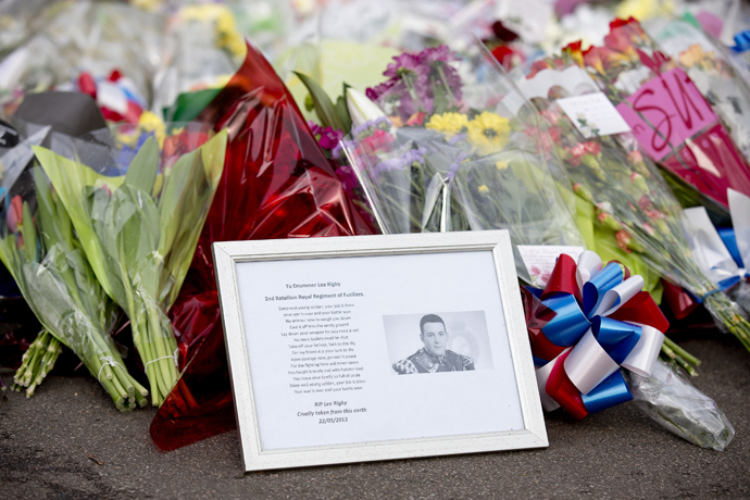 A framed photograph of Drummer Lee Rigby lies amongst floral tributes outside Woolwich Barracks in London on May 23, 2013, a day after the murder of a British soldier nearby (AFP Photo / Justin Tallis) 