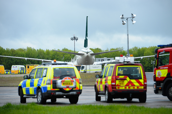 A Pakistan International Airlines is surrounded by emergency vehicles on the tarmac at Stansted Airport, southern England, May 24, 2013 (Reuters / Paul Hackett) 