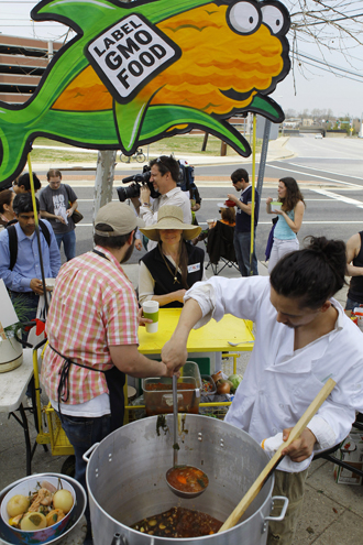 Servers Austin Ginsberg and Jonathan Bisagni feed soup to fellow protesters during an eat-in in front of the U.S. Food and Drug Administration's Center for Food Safety and Applied Nutrition in College Park. (Reuters / Gary Cameron)