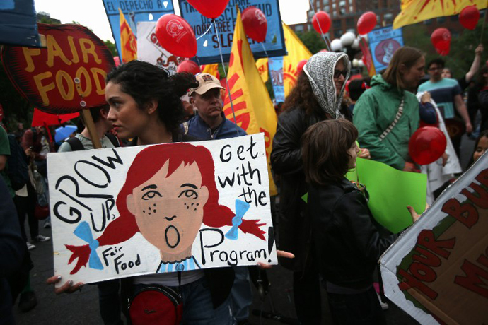 Protesters stage a demonstration outside a Wendy's restaurant on May 18, 2013 in New York City. The demonstrators called for the fast food chain to join Florida's Fair Food Program designed to improve wages for tomato pickers in the state. (AFP Photo / John Moore)